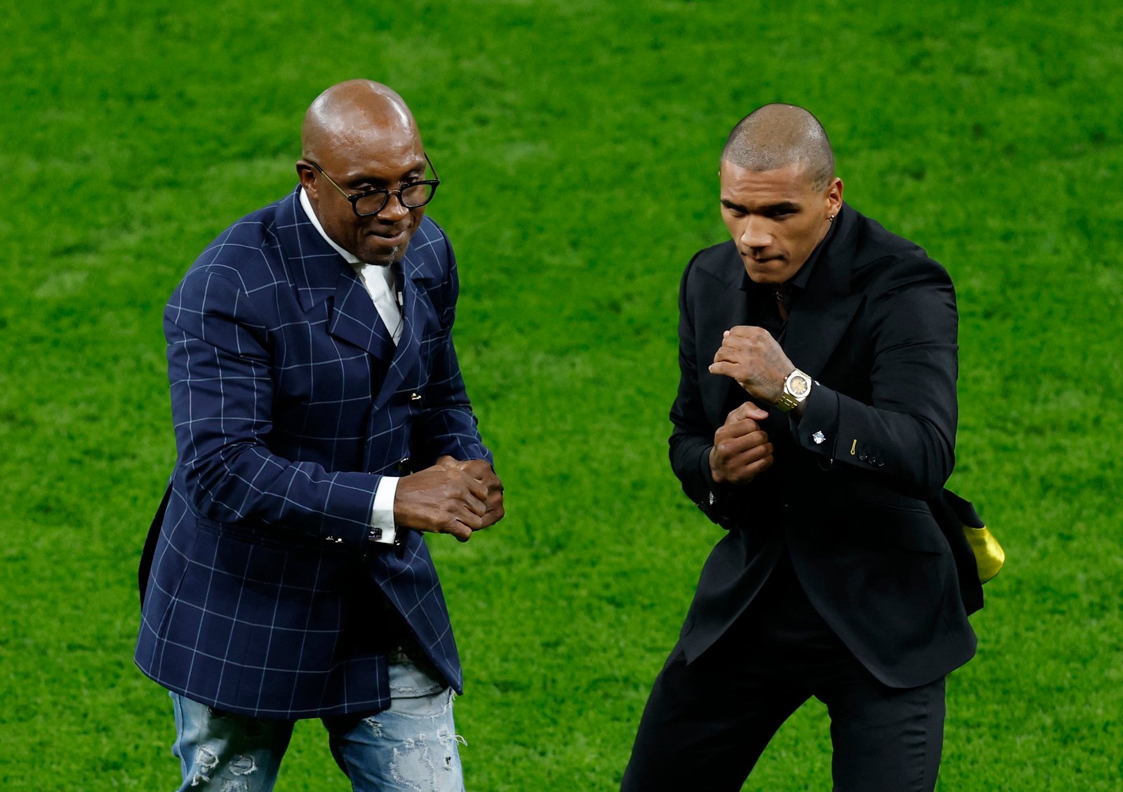 Conor Benn with his father Nigel, on the pitch at Tottenham Hotspur Stadium