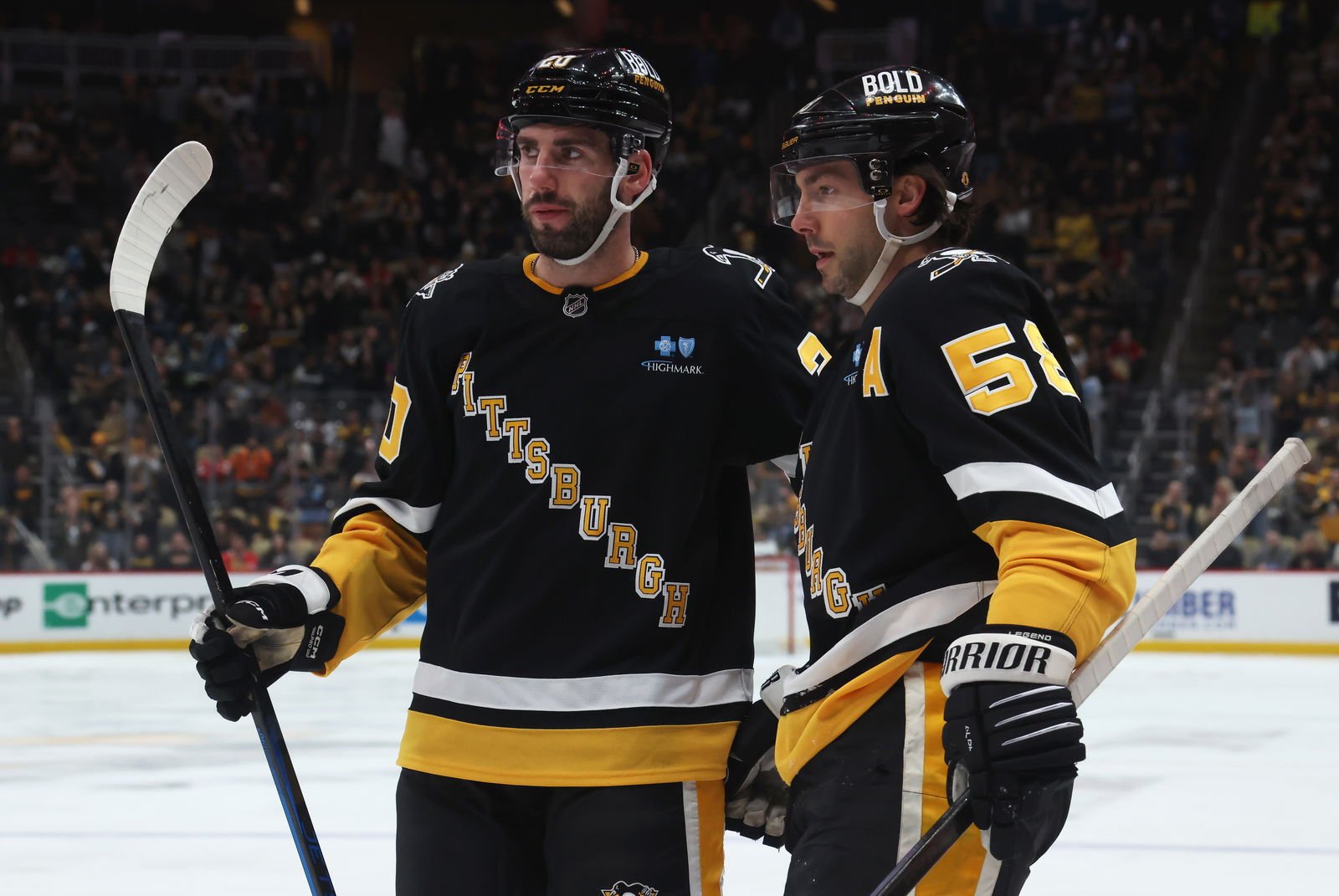 Apr 8, 2025; Pittsburgh, Pennsylvania, USA; Pittsburgh Penguins defenseman Conor Timmins (20) and defenseman Kris Letang (58) celebrate a goal by Letang against the Chicago Blackhawks during the third period at PPG Paints Arena. (Credit: Charles LeClaire-Imagn Images)