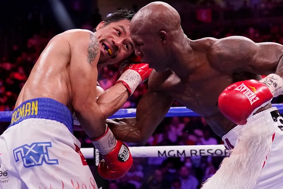 Yordenis Ugas punches Manny Pacquiao during a welterweight championship boxing match on Aug. 21, 2021, in Las Vegas.