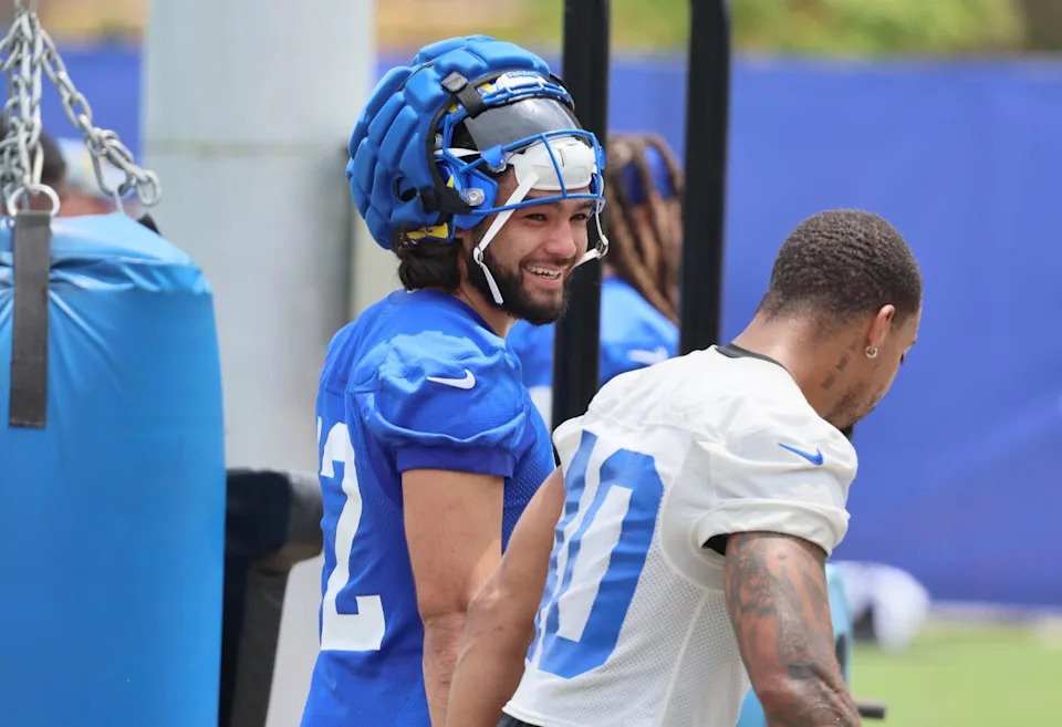 Rams wide receiver Puka Nacua, left, shares a laugh with linebacker Tony Fields II during organized team activities.