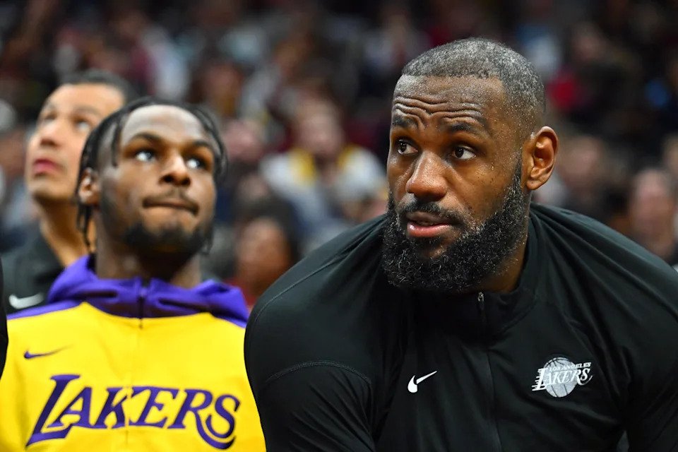 CLEVELAND, OHIO - OCTOBER 30: Bronny James #9 sits next to LeBron James #23 of the Los Angeles Lakers on the bench during the third quarter against the Cleveland Cavaliers at Rocket Mortgage Fieldhouse on October 30, 2024 in Cleveland, Ohio. The Cavaliers defeated the Lakers 134-110. NOTE TO USER: User expressly acknowledges and agrees that, by downloading and or using this photograph, User is consenting to the terms and conditions of the Getty Images License Agreement. (Photo by Jason Miller/Getty Images)