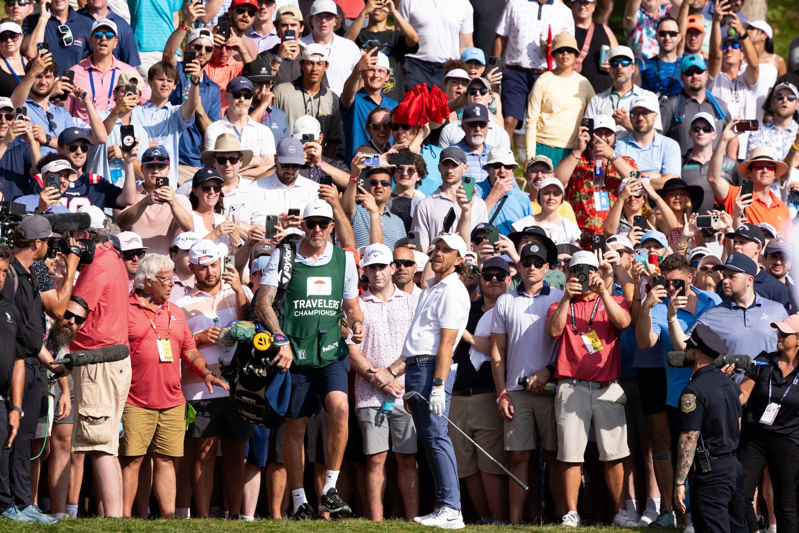Fleetwood reacts after playing a shot from the rough on the 15th hole