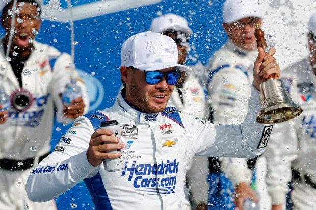 Kyle Larson celebrates in Victory Lane after winning a NASCAR...