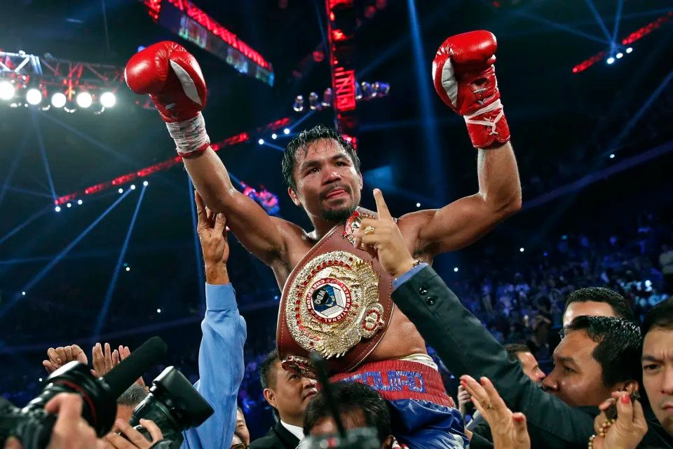 Manny Pacquiao from the Philippines wears the champion's belt after defeating Brandon Rios.