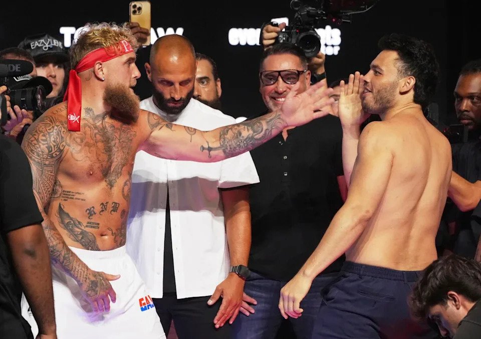 Jake Paul, left, and Julio César Chávez Jr. taunt each other following a weigh-in ahead of their boxing match
