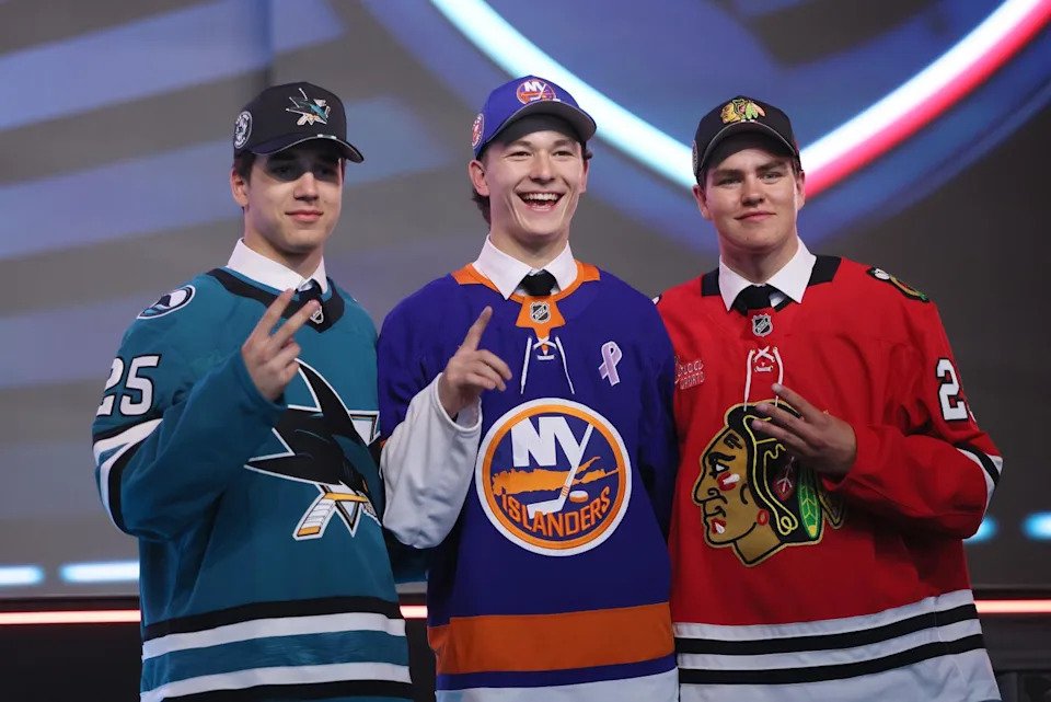 Matthew Schaefer stands between Michael Misa, left, and Anton Frondell after being selected 1-2-3 in the NHL draft.