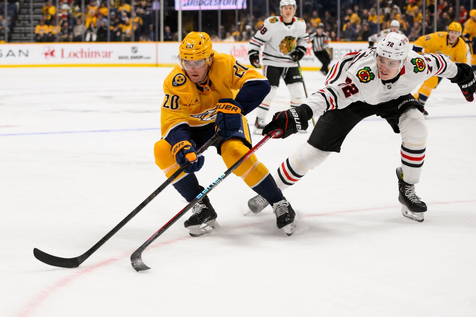 Jan 16, 2025; Nashville, Tennessee, USA; Nashville Predators defenseman Justin Barron (20) and Chicago Blackhawks defenseman Alex Vlasic (72) during the third period at Bridgestone Arena. Mandatory Credit: Steve Roberts-Imagn Images