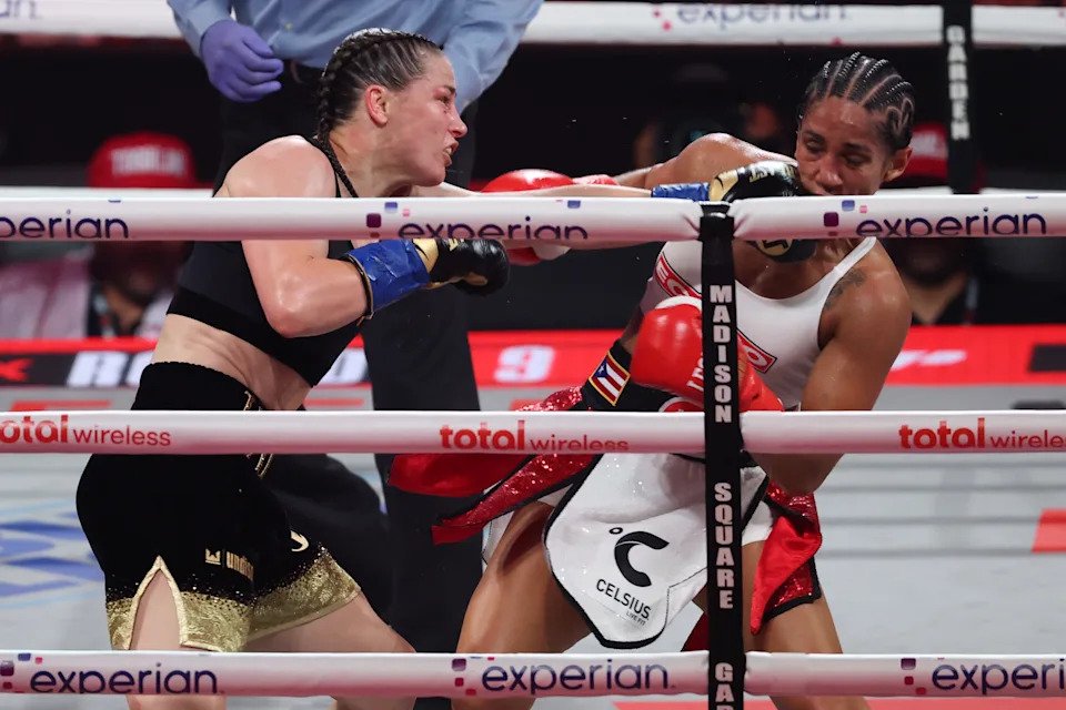 Jul 11, 2025; New York, New York, UNITED STATES; Amanda Serrano (red gloves) and Katie Taylor (blue gloves) fight during the undisputed super lightweight championship boxing bout at Madison Square Garden. Mandatory Credit: Vincent Carchietta-Imagn Images