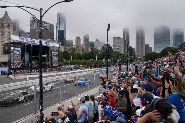 Fans cheer as competitors make begin their final 10 laps during the NASCAR Cup Series Grant Park 165 on July 6, 2025. (Audrey Richardson/Chicago Tribune)
