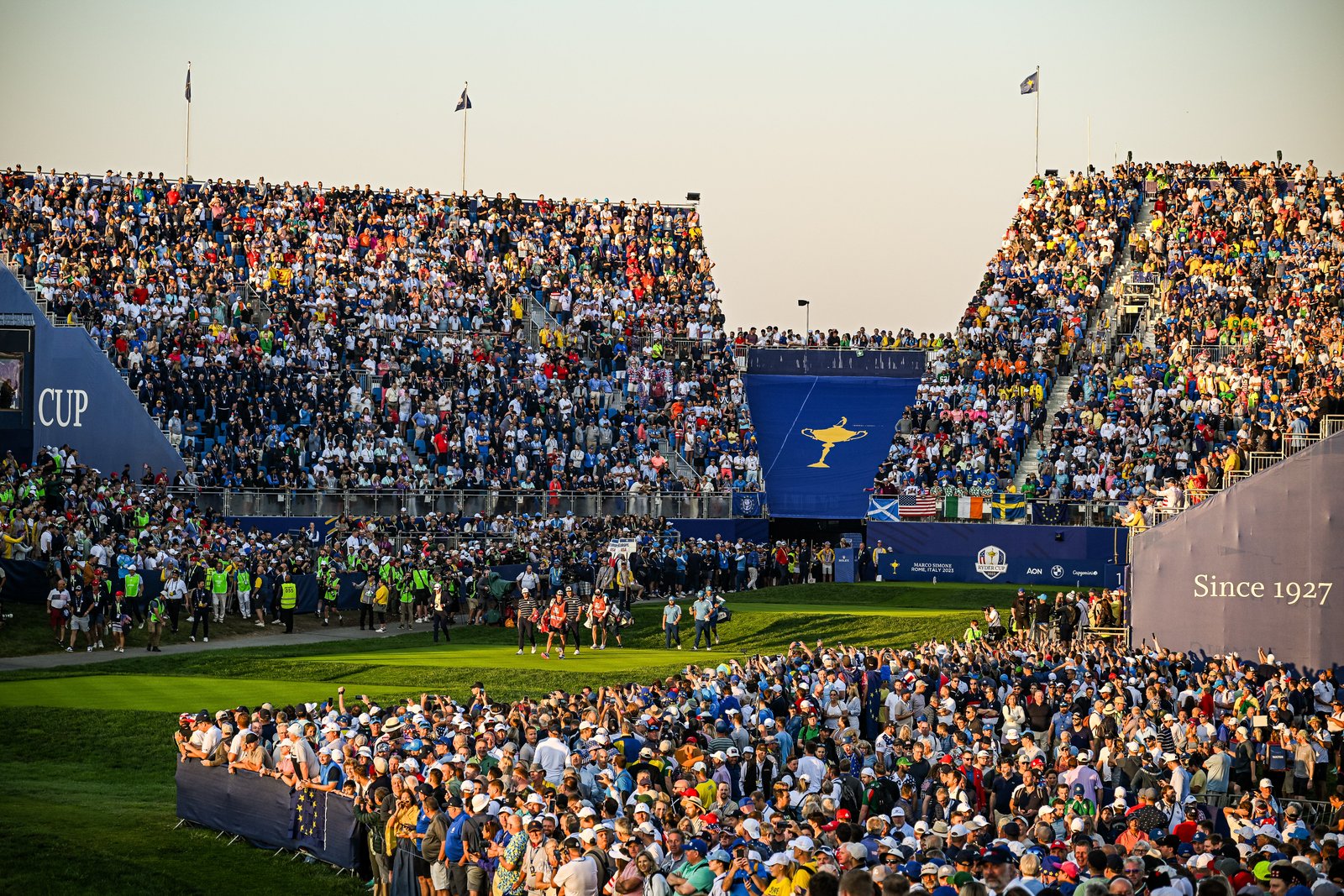 Tyrrell Hatton and Jon Rahm of Team Europe and Scottie Scheffler and Sam Burns of Team United States walk from the first tee