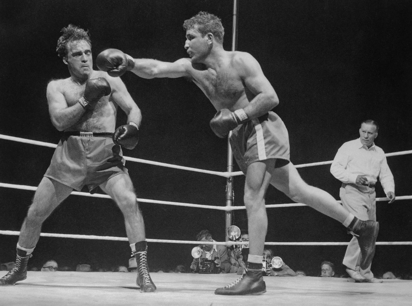 (Original Caption) Marcel Cerdan (L) of France backs just out of reach of Jake LaMotta's left early in the middleweight title fight in Detroit June 16. LaMotta took the title with a technical K.O. in the 10th.