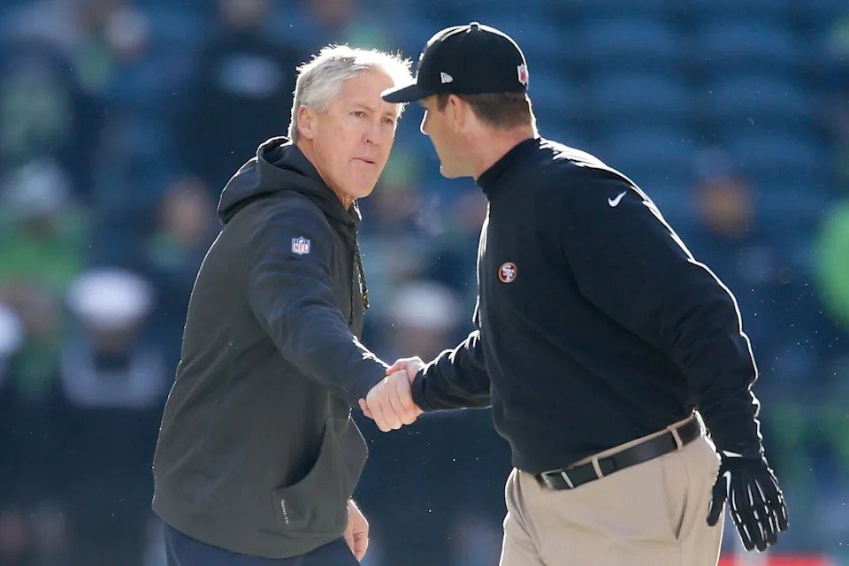 Seahawks coach Pete Carroll, left, shakes hands with 49ers coach Jim Harbaugh after a game in December 2014.