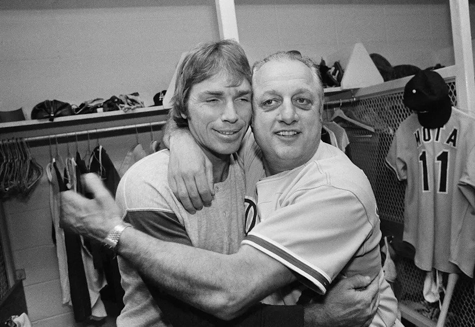 Los Angeles Dodgers manager Tommy Lasorda, right, hugs Bill Russell in the dressing room.