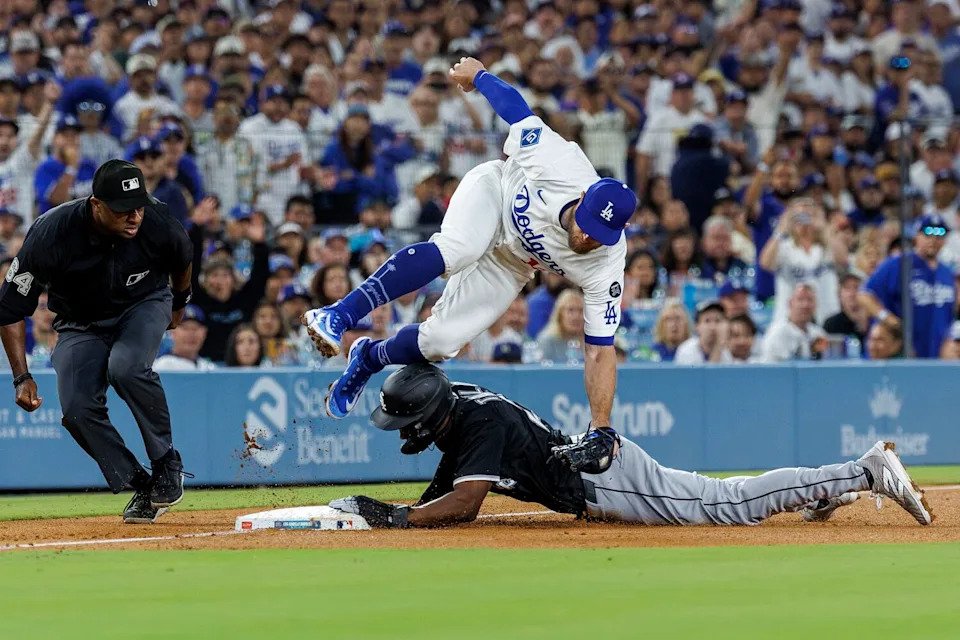 Dodgers third base Max Muncy is injured while tagging out Chicago White Sox outfielder Michael A. Taylor.