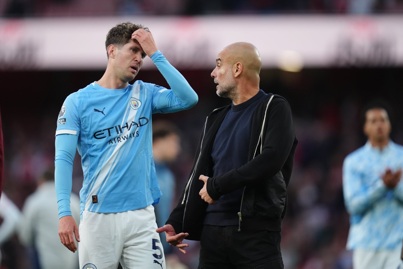 Pep Guardiola in discussion with John Stones at full-time