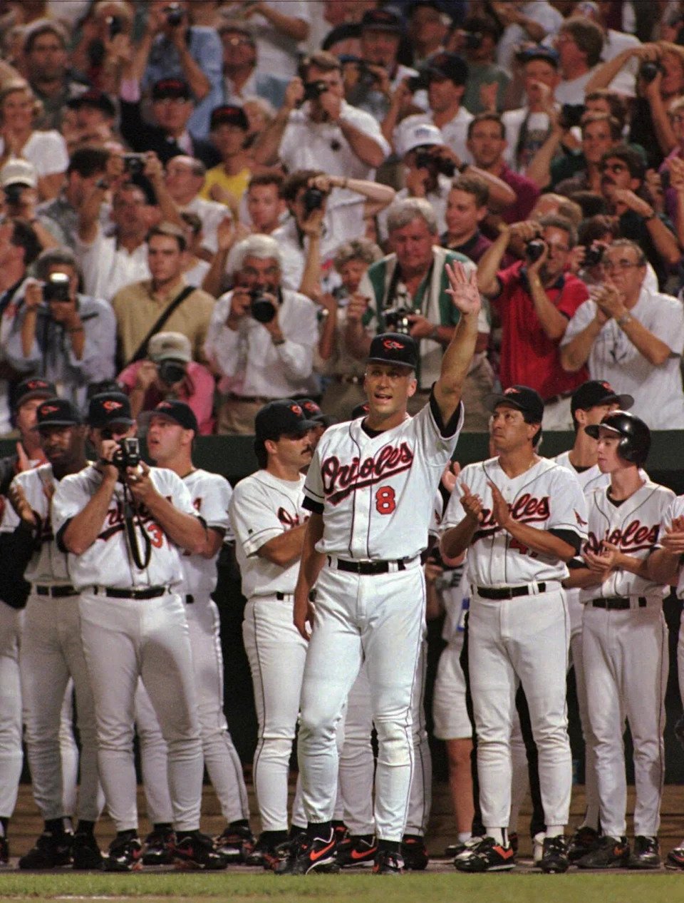 Baltimore Orioles Cal Ripken waves to the crowd in the middle of the fifth inning Sept. 6, 1995.