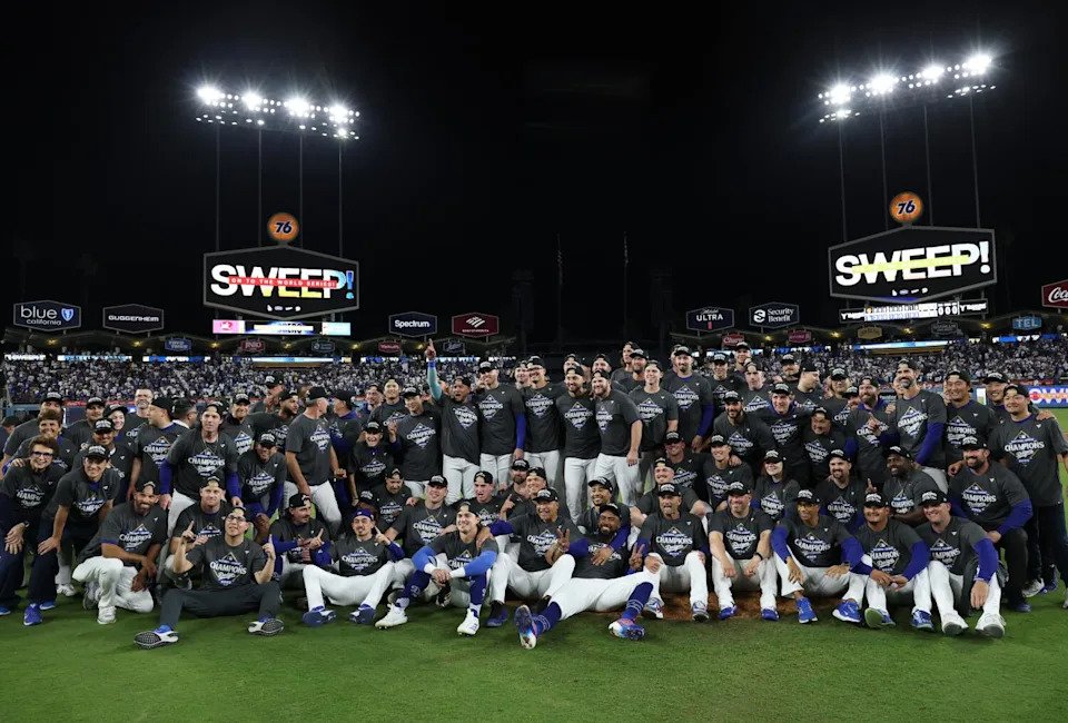 Dodgers players and coaches celebrate after sweeping the Milwaukee Brewers in the NLCS at Dodger Stadium on Friday night.