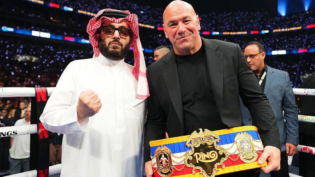 Alalshikh poses with a boxing belt with UFC president Dana White