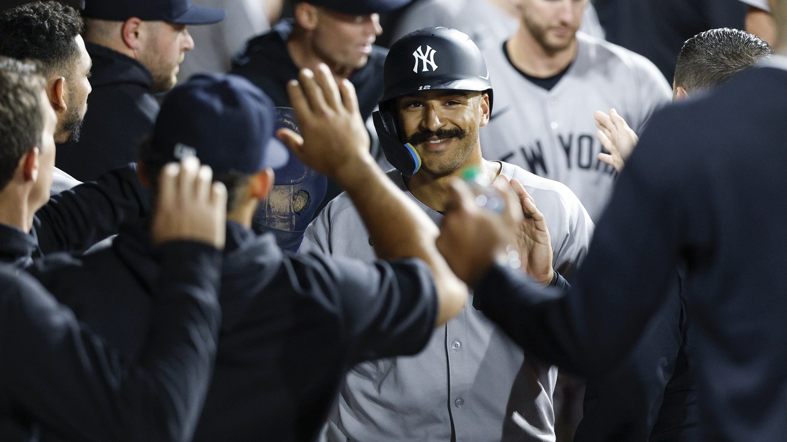 Aug 30, 2025; Chicago, Illinois, USA; New York Yankees center fielder Trent Grisham (12) celebrates with teammates in the dugout after scoring against the Chicago White Sox during the 11th inning at Rate Field.