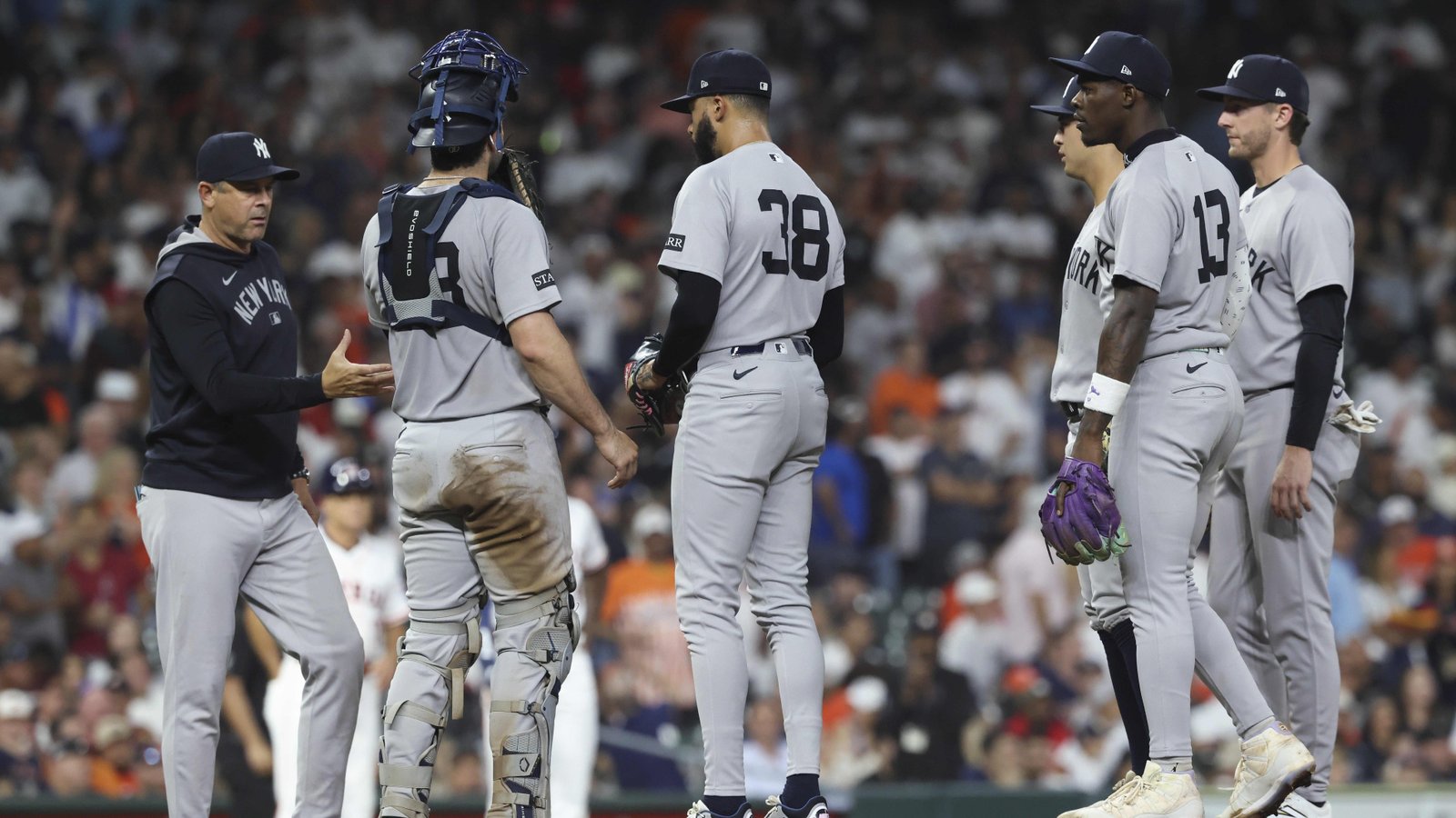 Sep 3, 2025; Houston, Texas, USA; New York Yankees relief pitcher Devin Williams (38) gives the ball to manager Aaron Boone during a pitching change in the eighth inning against the Houston Astros at Daikin Park.