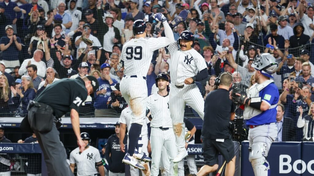 Judge rallies Yankees past Blue Jays 9-6 to save season and avert ALDS sweep