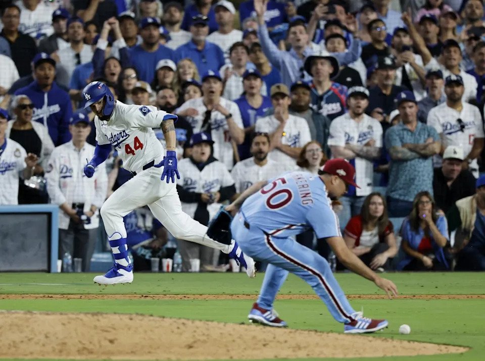 Andy Pages (44) watches as the Phillies pitcher Orion Kerkering (50) can't get to the ball.