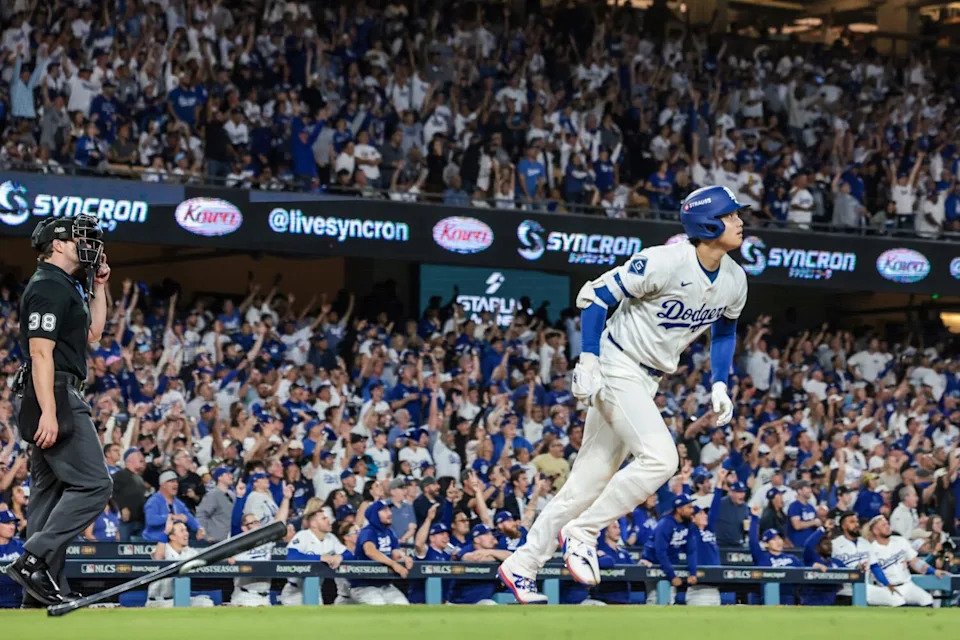 Dodgers designated hitter Shohei Ohtani (17) hits a long homer against the Milwaukee Brewers in NLCS.