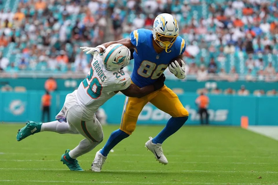 Chargers tight end Oronde Gadsden II tries to fight off Miami Dolphins linebacker Jordyn Brooks.