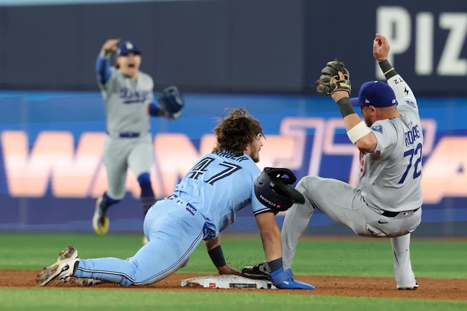 Second baseman Miguel Rojas gets the throw from first baseman Kiké Hernández.