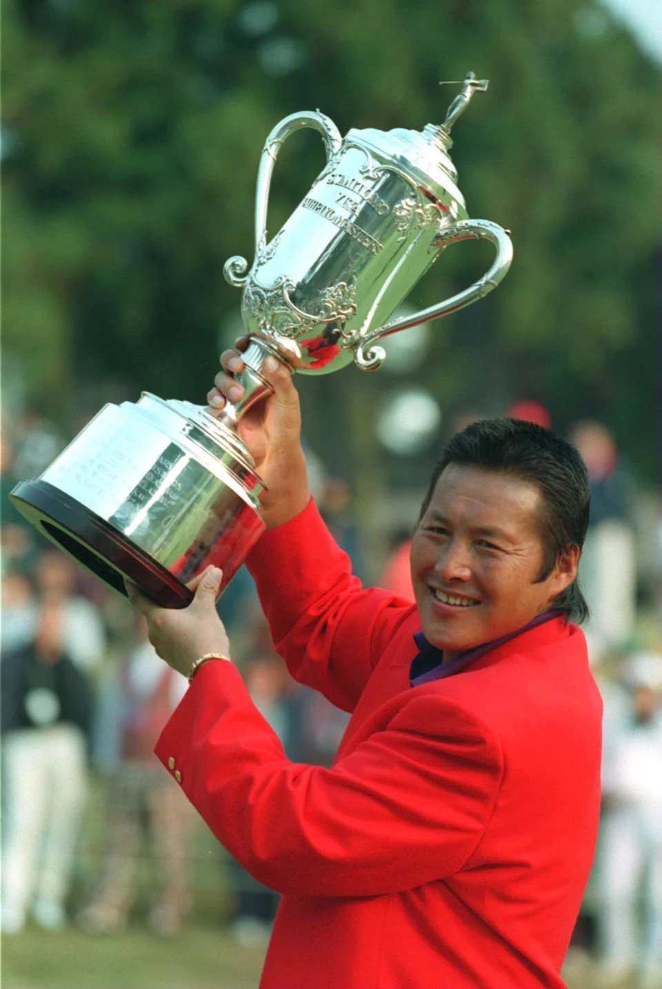 Masashi "Jumbo" Ozaki lifts the Sumitomo Visa Taheiyo Masters Trophy in Gotemba, Japan.