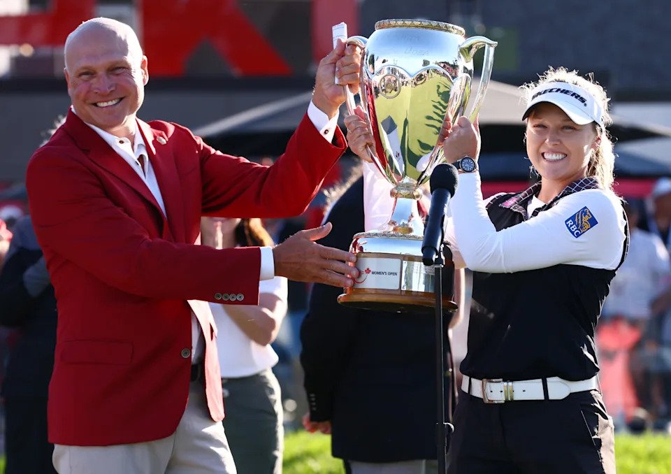 Brooke M. Henderson of Canada is presented with the trophy after winning the CPKC Women's Open 2025 at Mississaugua Golf and Country Club on August 24, 2025 in Mississauga, Ontario.
