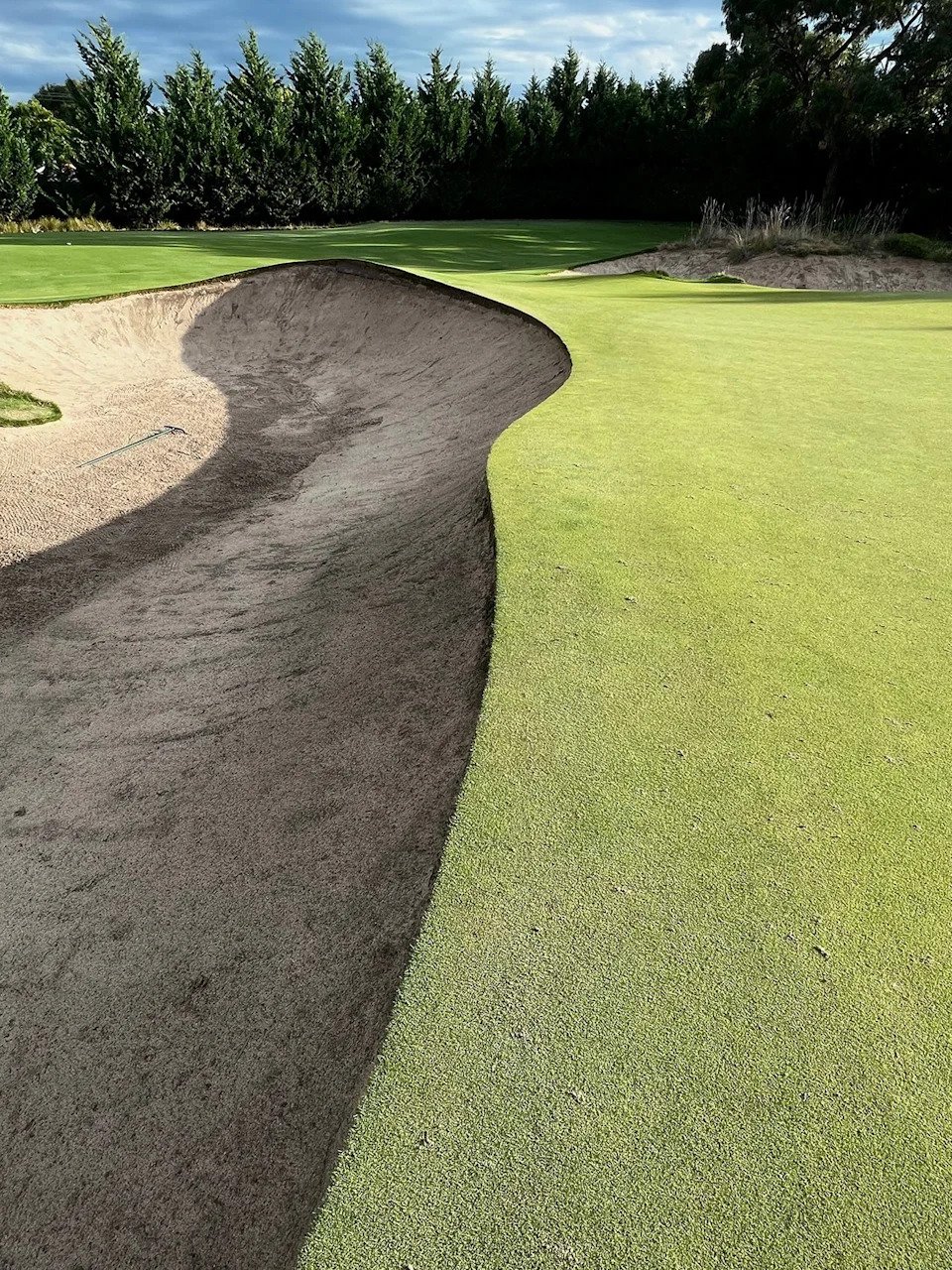 The hard-edged bunker lip on No. 12 at Victoria Golf Club perfectly illustrates the style and construction of bunkers in the Sandbelt, with the putting surface extending all the way to the bunker's lip with no fringe or rough in between. (Jason Lusk/Golfweek)