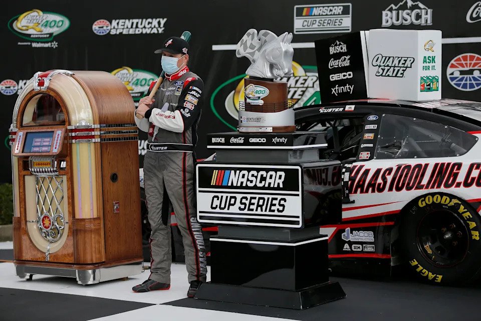 Monster Energy NASCAR Cup Series driver Cole Custer (41) wears a mask as he celebrates in the winner's circle after winning the NASCAR Cup Series 10th Annual Quaker State 400 at Kentucky Speedway in Sparta, Ky., on Sunday, July 12, 2020.