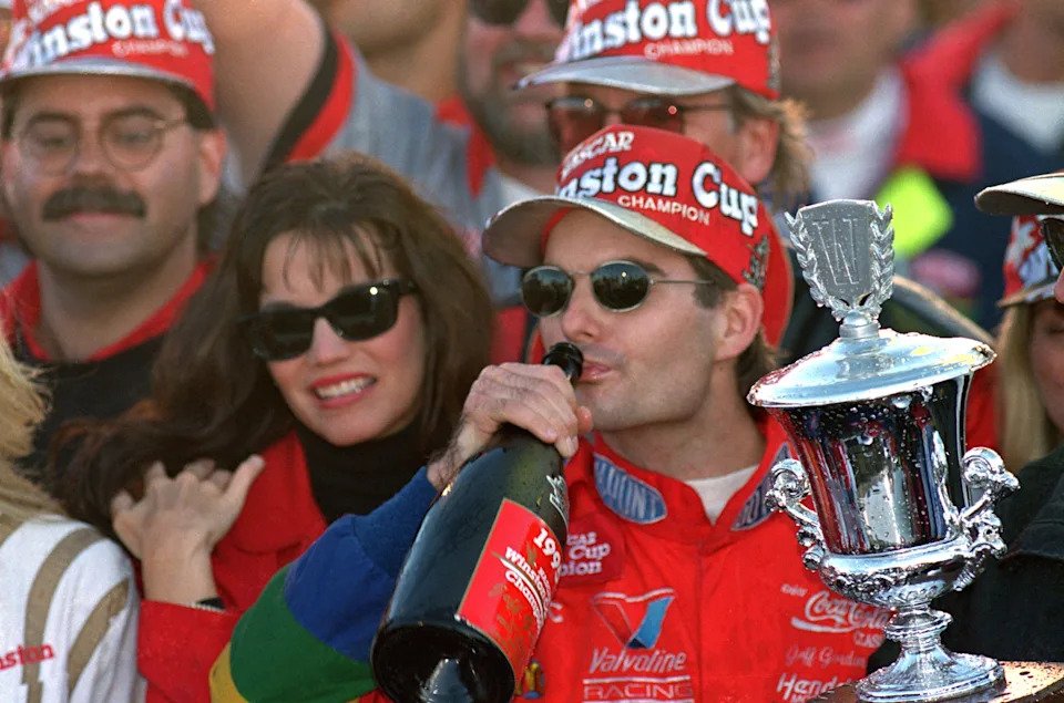 ATLANTA - NOVEMBER 12: Jeff Gordon of DuPont Chevrolet celebrates in victory lane drinking champagne after winning the Winston Cup championship in the NASCAR NAPA 500 at the Atlantic Motor Speedway on November 12, 1995 in Atlanta, Georgia. (Photo by David Taylor/Getty Images)