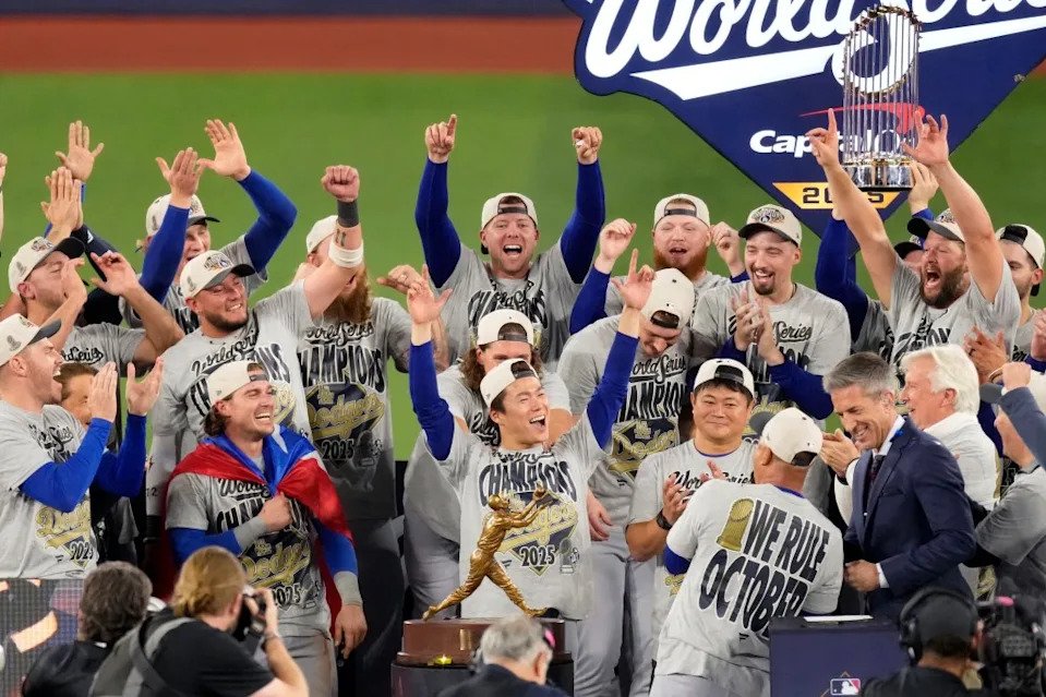 Toronto, Ontario, CAN; Los Angeles Dodgers pitcher Yoshinobu Yamamoto (18) celebrates on the podium after defeating the Toronto Blue Jays in game seven of the 2025 MLB World Series at Rogers Centre. Kevin Sousa-Imagn Images