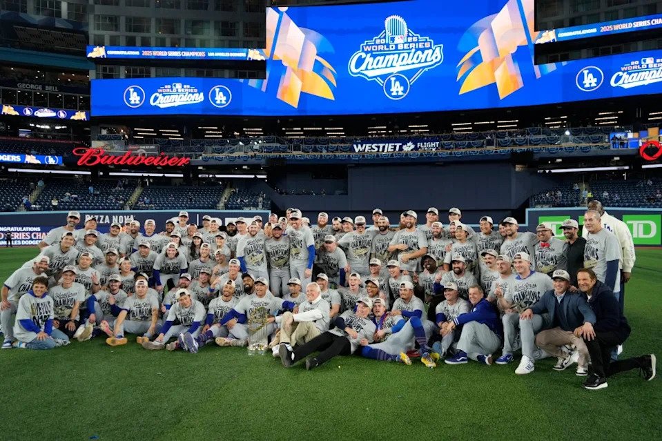 The LA Dodgers pose for a group photo on the field after defeating the Toronto Blue Jays in game seven of the 2025 MLB World Series at Rogers Centre. John E. Sokolowski-Imagn Images