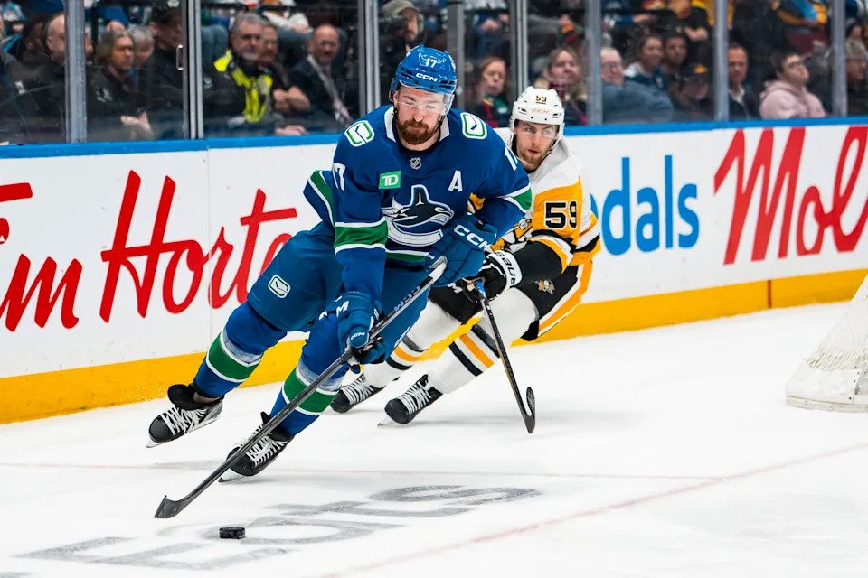 Jan 25, 2026; Vancouver, British Columbia, CAN; Pittsburgh Penguins forward Egor Chinakhov (59) pursues Vancouver Canucks defenseman Filip Hronek (17) in the third period at Rogers Arena. Mandatory Credit: Bob Frid-Imagn Images