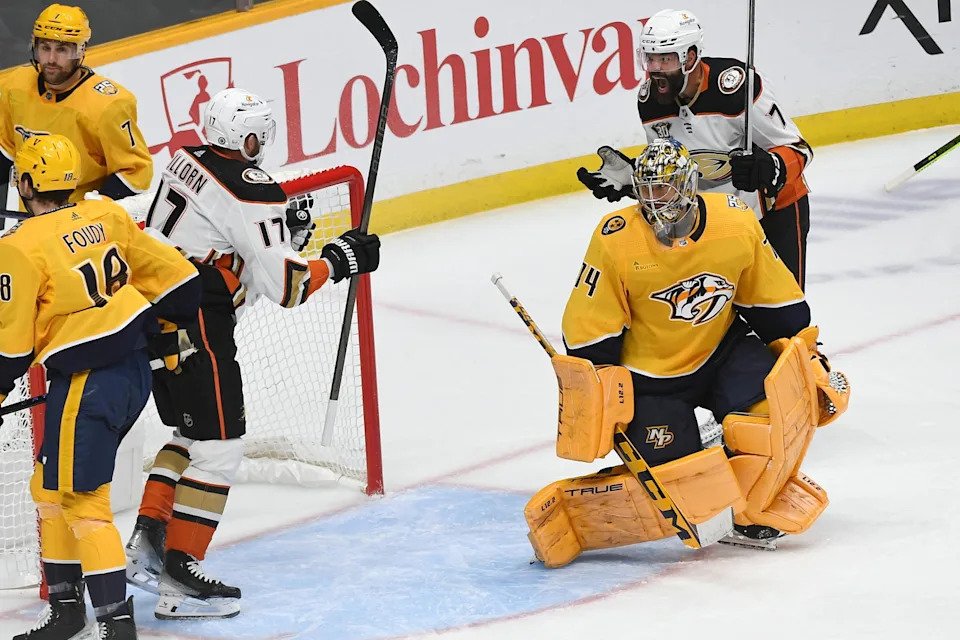 Nov 14, 2023; Nashville, Tennessee, USA; Anaheim Ducks defenseman Radko Gudas (7) and left wing Alex Killorn (17) celebrate after a goal against Nashville Predators goaltender Juuse Saros (74) during the third period at Bridgestone Arena. Mandatory Credit: Christopher Hanewinckel-Imagn Images