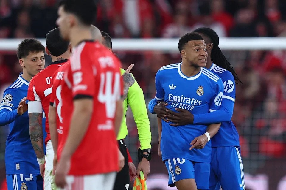 Kylian Mbappe is held back as he clashes with Benfica players after the match was halted (Reuters)