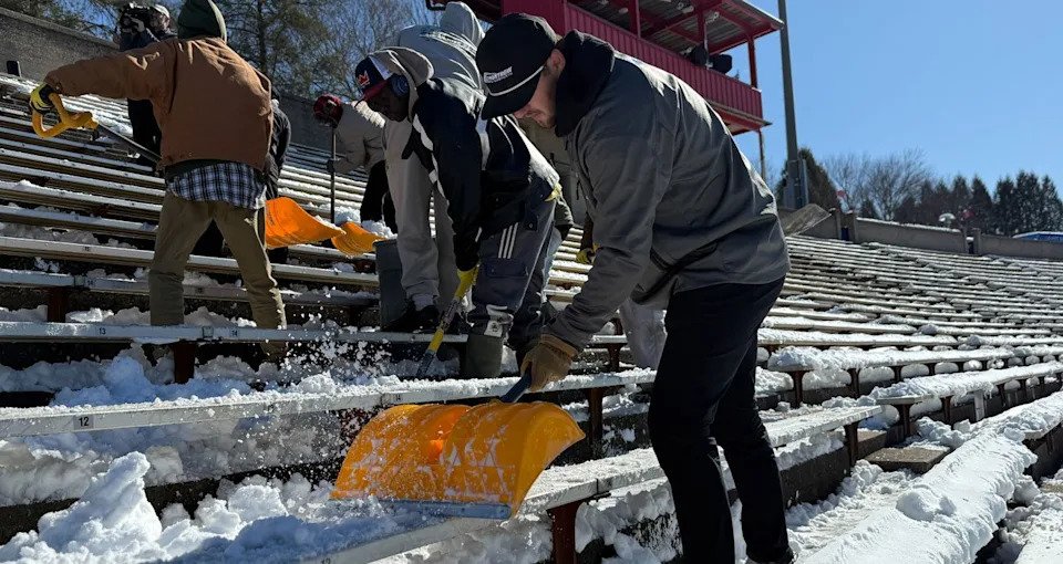Todd Gilliland removes snow and ice from Bowman Gray Stadium grandstands.