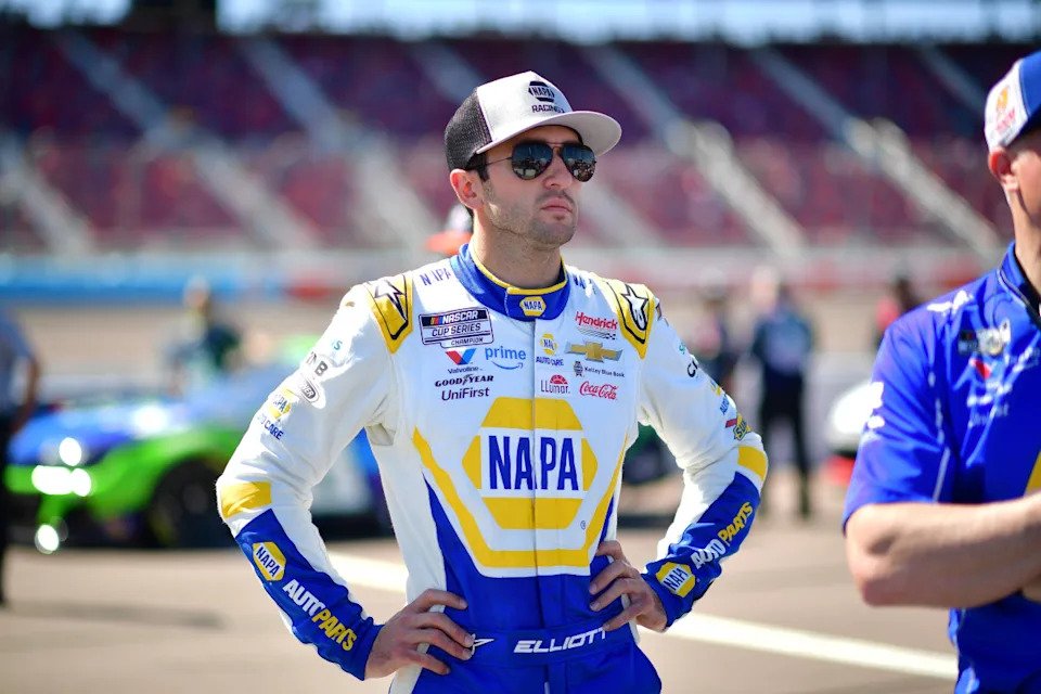 Chase Elliott stands on pit road during NASCAR Cup Series qualifying.Gary A. Vasquez-Imagn Images