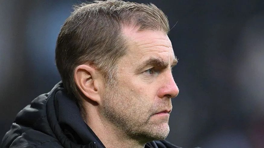 Harrogate Town manager Simon Weaver looks on