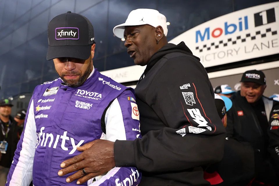 Michael Jordan speaks to his Team 23XI Racing driver Bubba Wallace after teammate Tyler Reddick won the 2026 Daytona 500.