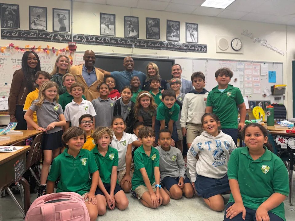 Brittney Payton, back left, joins third-grade teacher Mary Crippen, Pro Football Hall of Famer Dwight Stephenson and Jarrett Payton, along with Crippen's third-grade class, to present the Hall's Award of Character honoring Crippen's innovative work in the classroom.