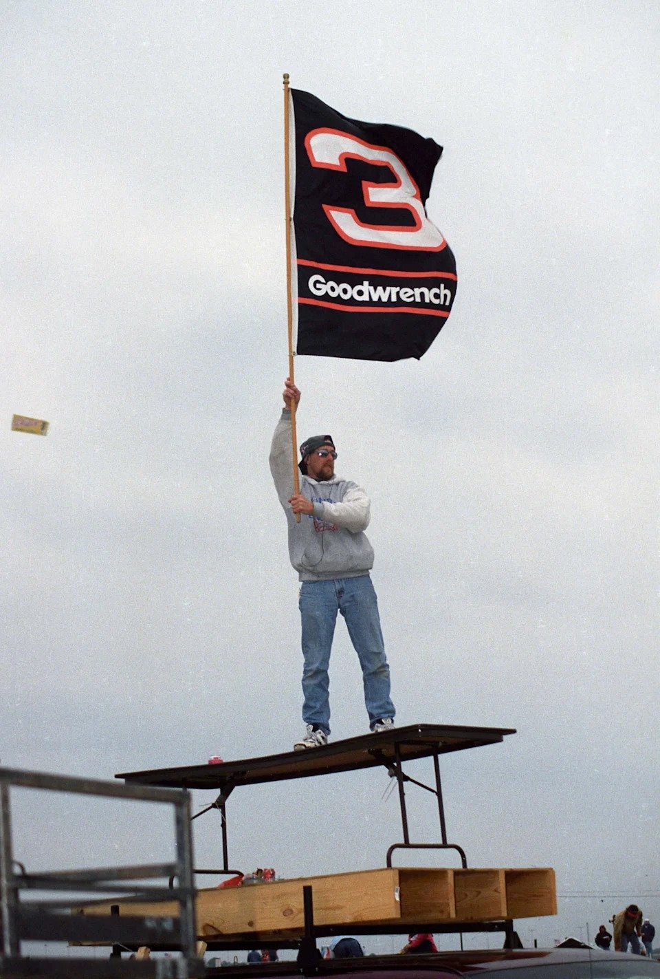 A fan of NASCAR Winston Cup Series driver Dale Earnhardt waves a #3 flag.