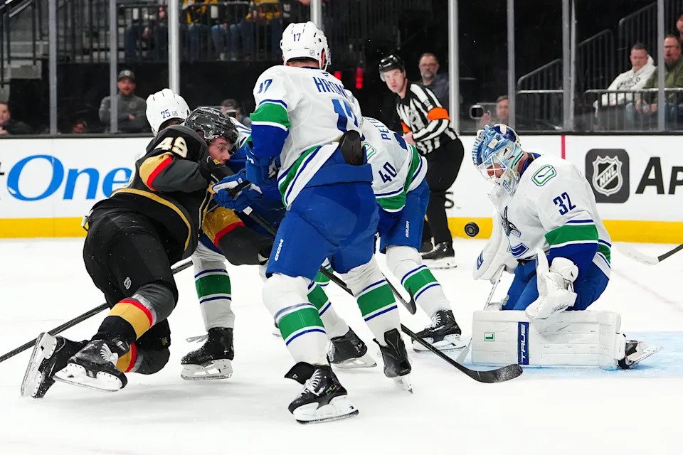 Feb 4, 2026; Las Vegas, Nevada, USA; Vancouver Canucks goaltender Kevin Lankinen (32) makes a save against Vegas Golden Knights left wing Ivan Barbashev (49) during the second period at T-Mobile Arena. Mandatory Credit: Stephen R. Sylvanie-Imagn Images