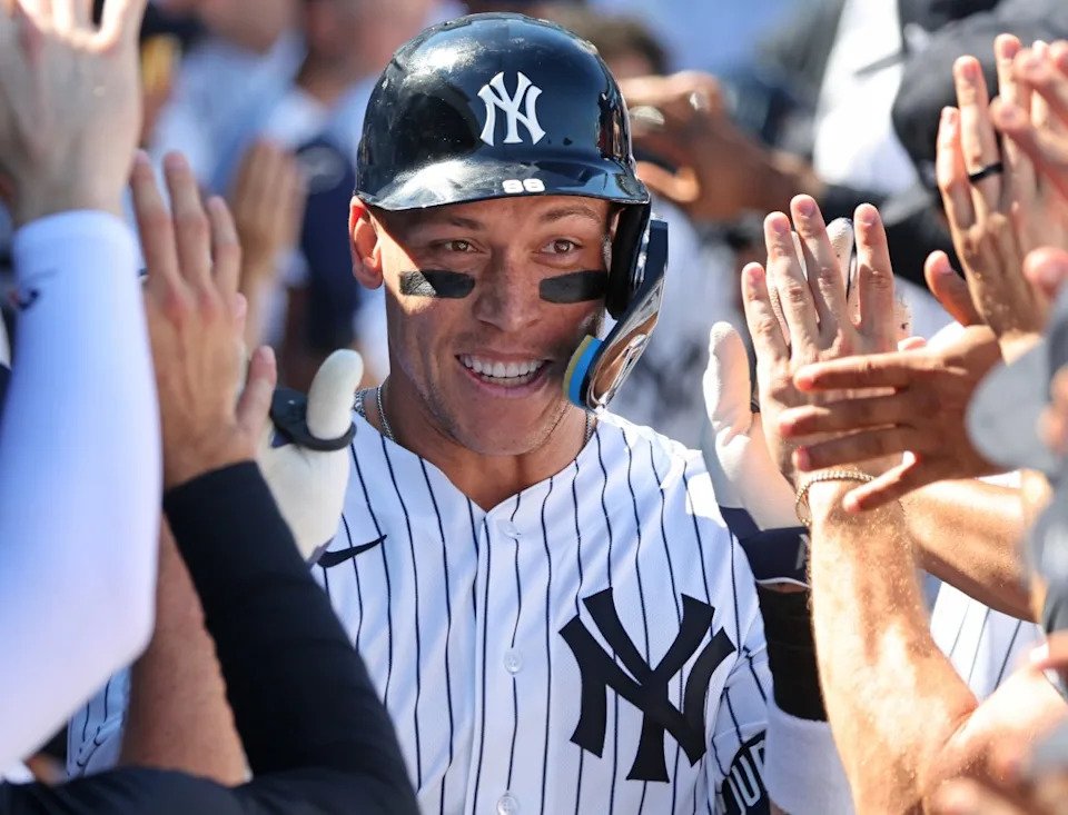 A smiling Aaron Judge accepts congratulations from his teammates after belting the first of his two home runs in the Yankees’ spring training blowout win over the Tigers. Charles Wenzelberg / New York Post