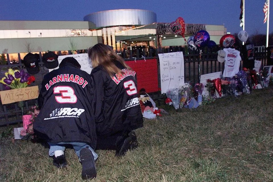 NASCAR fans Ronnie (L) and Vickie Pethel of Concord, NC, say a prayer at a memorial outside driver Dale Earnhardt's corporate headquarters.