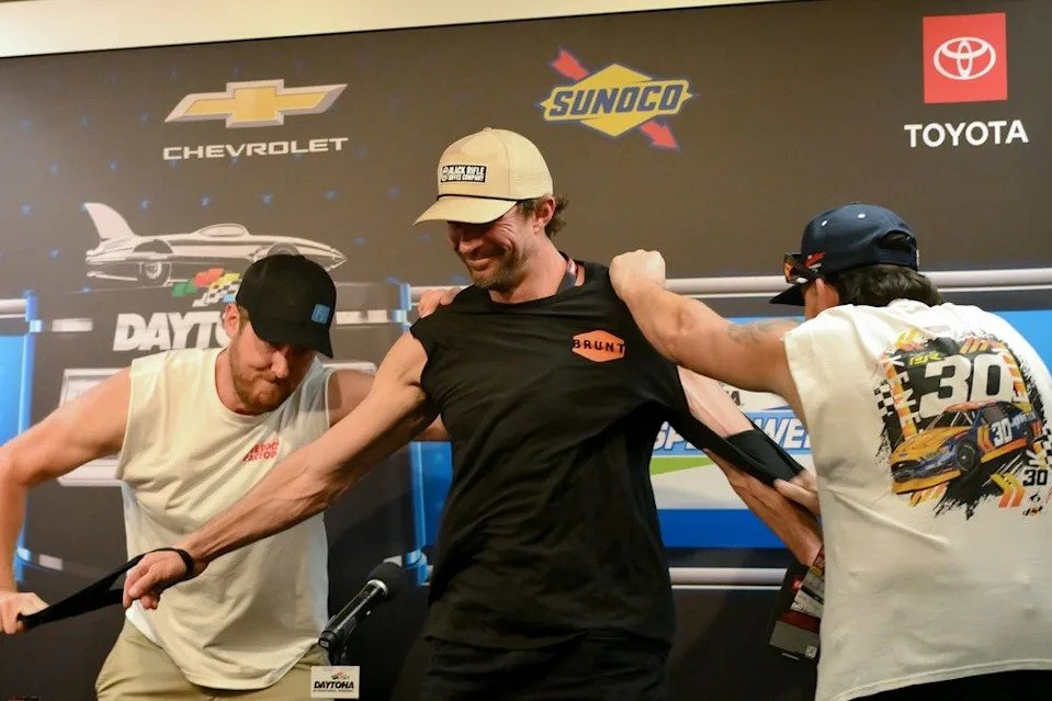 Cleetus McFarland rips the sleeves off Travis Pastrana's shirt