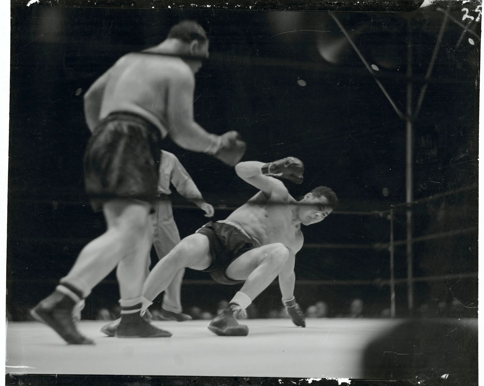 (Original Caption) Louis Scores Technical Knockout Over Galento. New York, N.Y.: Heavyweight champion Joe Louis successfully Tony Galento in the fourth round of their bout at Yankee Stadium, New York City, June 28. Photo shows Galento (left) flooring Louis with a hard left during the third round.